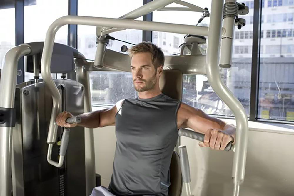 Sinə əzələsini məşq etmək üçün əsas fitness avadanlığı - oturmuş sinə təkan məşqçisi